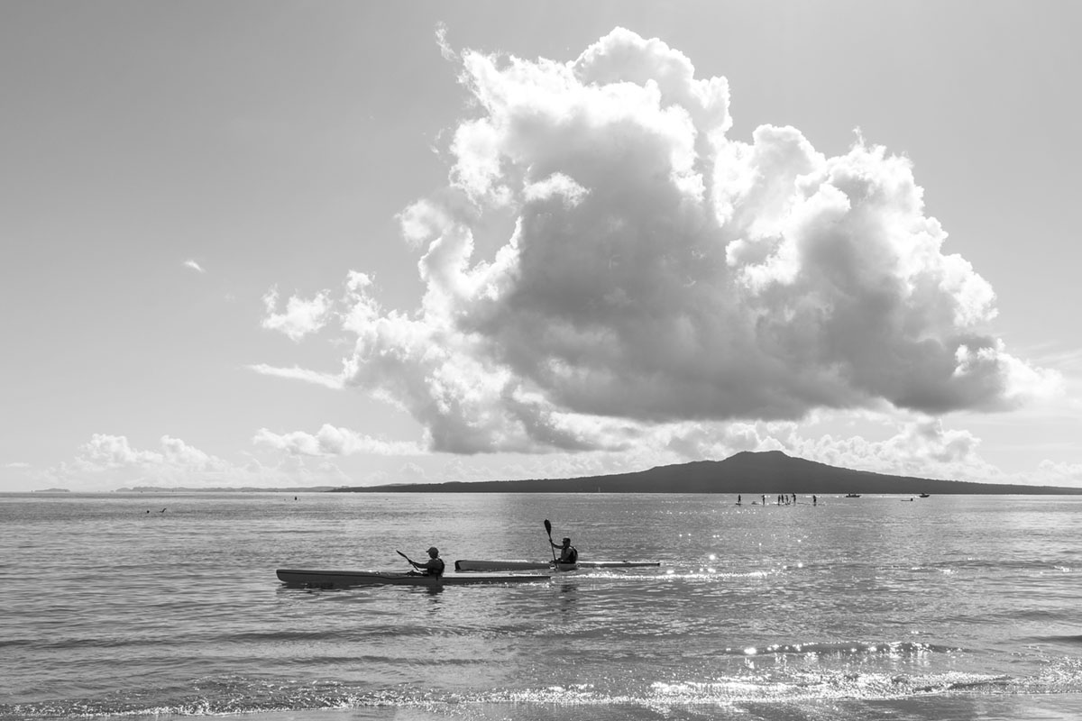 Kayakers in Auckland with Rangitoto in background